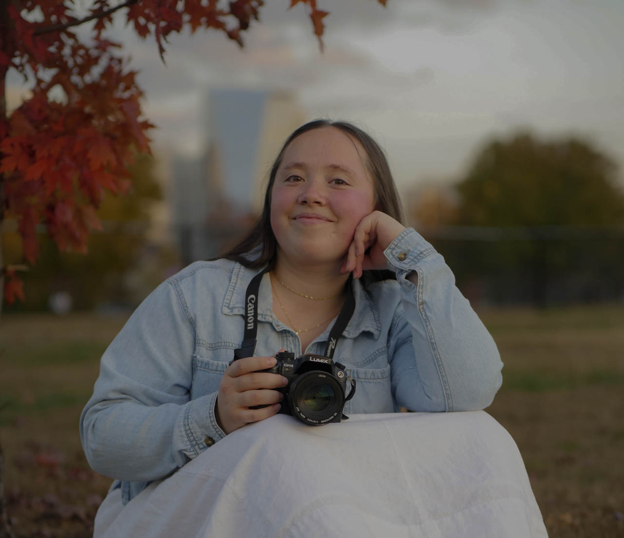 Marilyn holding her camera in the autumn light